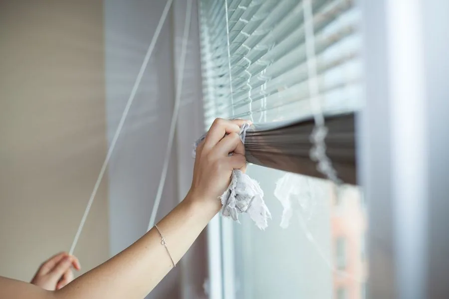 Hand Young Woman Cleaning Blinds By Cloth Housework